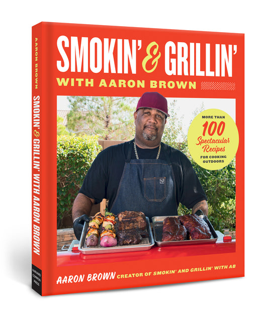 Signed Smokin’ and Grillin’ with Aaron Brown Cookbook by Smokin and Grillin wit AB, featuring Aaron Brown at the grill and over 100 outdoor grilling recipes.
